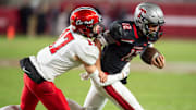 Thompson's Trakel Howard (12) runs the ball as Central Phenix City faces Thompson in the Class 7A football state championship at Bryant-Denny Stadium in Tuscaloosa, Ala., on Wednesday, Dec. 6, 2023. Central Phenix City defeated Thompson 21-19.