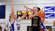 Tocoi Creek's Audrey Beyer (21) drives the lane against Bartram Trail's Alana Larson (15) during the second quarter of the District 3-6A girls basketball final Friday, Feb. 7, 2025 at Bartram Trail High School in St. Johns, Fla. The Tocoi Creek Toros defeated the Bartram Trail Bears 52-37.