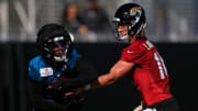 Jacksonville Jaguars quarterback Trevor Lawrence (16) hands off to running back Travis Etienne Jr. (1) during the first day of an NFL football training camp practice Wednesday, July 24, 2024 at EverBank Stadium’s Miller Electric Center in Jacksonville, Fla.