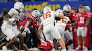Texas Longhorns quarterback Arch Manning (16) runs the ball for a first down on fourth down in the second quarter of the Cotton Bowl Classic during the College Football Playoff semifinal game at AT&T Stadium in Arlington, Texas on January, 10, 2025.