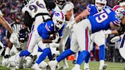 Buffalo Bills running back James Cook, carrying the ball, keeps low as teammate Buffalo Bills offensive tackle Spencer Brown blocks opening a spot for him during first half action at the Buffalo Bills divisional game against the Baltimore Ravens at Highmark Stadium in Orchard Park on Jan. 19, 2025.