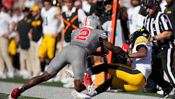 Oct 5, 2024; Columbus, OH, USA; Ohio State Buckeyes safety Caleb Downs (2) tackles Iowa Hawkeyes wide receiver Jacob Gill (5) after a catch in the first quarter during the NCAA football game at Ohio Stadium.