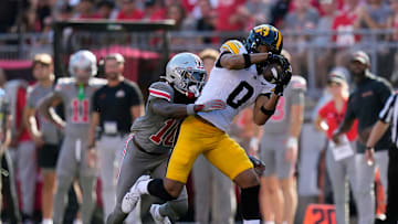 Oct 5, 2024; Columbus, OH, USA; Iowa Hawkeyes wide receiver Jarriett Buie (0) makes a catch against Ohio State Buckeyes cornerback Denzel Burke (10) in the second quarter during the NCAA football game at Ohio Stadium.