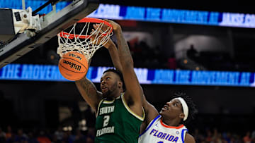 South Florida Bulls forward Jamille Reynolds (2) dunks on Florida Gators center Rueben Chinyelu (9) during the second half of an NCAA men’s basketball matchup Monday, Nov. 4, 2024 at VyStar Veterans Memorial Arena in Jacksonville, Fla. Florida defeated South Florida 98-83. [Corey Perrine/Florida Times-Union]