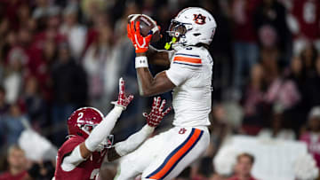 Auburn Tigers wide receiver Cam Coleman (8) catches a touchdown pass over Alabama Crimson Tide defensive back Zabien Brown (2) as Auburn Tigers take on Alabama Crimson Tide at Bryant-Denny Stadium in Tuscaloosa, Ala., on Saturday, Nov. 30, 2024. Alabama Crimson Tide defeated Auburn Tigers 28-14.