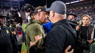 Auburn Tigers head coach Hugh Freeze and Kentucky Wildcats head coach Mark Stoops shake hands after Auburn Tigers take on Kentucky Wildcats at Jordan-Hare Stadium in Auburn, Ala. on Saturday, Nov. 1, 2025. Kentucky Wildcats defeated Auburn Tigers 10-3.