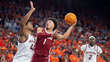 Alabama Crimson Tide guard Mark Sears (1) goes up for a layup on Auburn Tigers center Dylan Cardwell (44)