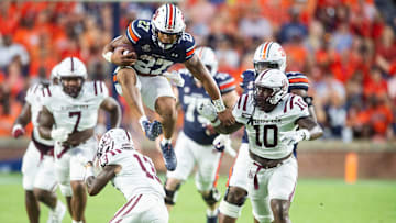 Auburn Tigers running back Jarquez Hunter (27) hurdles Alabama A&M Bulldogs defensive back Elijah Eberhardt (13) as Auburn Tigers takes on Alabama A&M Bulldogs at Jordan-Hare Stadium in Auburn, Ala., on Saturday, Aug. 31, 2024.
