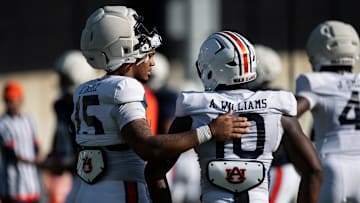 Auburn Tigers defensive lineman Keldric Faulk (15) and Amaris Williams talk between drills during football practice at Woltosz Football Performance Center in Auburn, Ala., on Thursday, April 10, 2025.