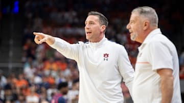 Auburn Tigers assistant coach Steven Pearl and head coach Bruce Pearl talk with their team from the bench as Auburn Tigers take on Ole Miss Rebels at Neville Arena in Auburn, Ala., on Wednesday, Feb. 26, 2025.