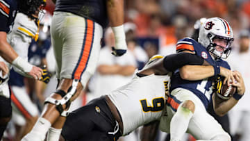 Auburn Tigers quarterback Jackson Arnold (11) is sacked by Missouri Tigers defensive end Zion Young (9) as Auburn Tigers take on Missouri Tigers at Jordan-Hare Stadium in Auburn, Ala. on Saturday, Oct. 18, 2025. Missouri Tigers defeated the Auburn Tigers 23-17 in 2OT.