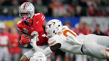 Ohio State Buckeyes wide receiver Emeka Egbuka (2) makes a catch against Texas Longhorns defensive back Jaylon Guilbeau (3) and linebacker Anthony Hill Jr. (0).