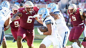 Nov 2, 2024; Tallahassee, Florida, USA;  Florida State Seminoles defensive tackle Darrell Jackson Jr (6) pursues North Carolina Tarheels running back Davion Gause (21) in the second quarter at Doak S. Campbell Stadium. Mandatory Credit: Robert Myers-Imagn Images