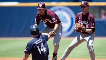 Auburn Tigers' Cade Belyeu (14) is tagged out by Texas A&M Aggies' Kaeden Kent (6) as Auburn Tigers take on Texas A&M Aggies during the SEC baseball tournament at Hoover Met in Birmingham, Ala., on Thursday, May 22, 2025. Texas A&M Aggies defeated Auburn Tigers 3-2.