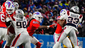 Buffalo Bills running back James Cook finds an opening to run through will the ball during second half action.