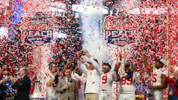 Dec 30, 2023; Atlanta, GA, USA; Mississippi Rebels head coach Lane Kiffin holds up the Peach Bowl trophy after a victory against the Penn State Nittany Lions at Mercedes-Benz Stadium. Mandatory Credit: Brett Davis-USA TODAY Sports
