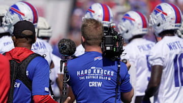 A NFL Crew from Hard Knocks follows the Bills on the field during opening day of the Buffalo Bills training camp.
