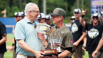SEC Commissioner Greg Sankey presents the trophy to Vanderbilt Commodores head coach Tim Corbin as Ole Miss Rebels take on Vanderbilt Commodores during the SEC baseball tournament championship game at Hoover Met in Birmingham, Ala., on Sunday, May 25, 2025. Vanderbilt Commodores defeated Ole Miss Rebels 3-2.