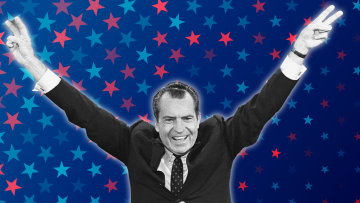 Richard Nixon flashes his trademark “victory” sign.