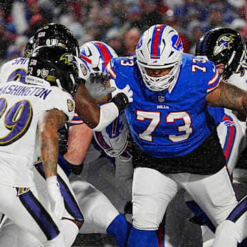 Buffalo Bills Dion Dawkins blocks for quarterback Josh Allen, behind him, who sneaks in for a touchdown during first half action at the Buffalo Bills divisional game against the Baltimore Ravens at Highmark Stadium in Orchard Park on Jan. 19, 2025.