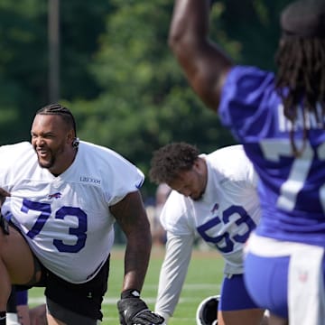 Buffalo Bills offensive tackle Dion Dawkins laughs after teammate’s comment as they stretch before practice t the Buffalo Bills training camp at St. John Fisher University in Pittsford on July 24, 2025.