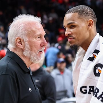 Feb 11, 2023; Atlanta, Georgia, USA; San Antonio Spurs head coach Gregg Popovich talks to Atlanta Hawks guard Dejounte Murray (5) after a game at State Farm Arena. Mandatory Credit: Brett Davis-Imagn Images