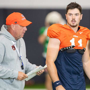 Auburn Tigers head coach Hugh Freeze talks with quarterback Jackson Arnold (11) during practice at Woltosz Football Performance Center in Auburn, Ala.