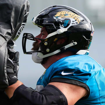 Jacksonville Jaguars center Mitch Morse (65) hits a sled during the third day of an NFL football training camp practice Friday, July 26, 2024 at EverBank Stadium’s Miller Electric Center in Jacksonville, Fla.