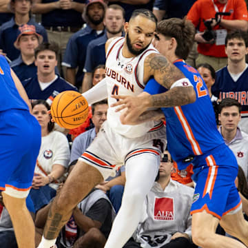 Auburn Tigers forward Johni Broome (4) makes a post move on Florida Gators center Alex Condon (21) as Auburn Tigers take on Florida Gators at Neville Arena in Auburn, Ala., on Saturday, Feb. 8, 2025.