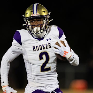 Booker's Tyren Wortham (2) rushes for yards during the first quarter of an FHSAA Class 3A state football semifinal matchup Friday, Dec. 6, 2024 at Raines High School in Jacksonville, Fla.