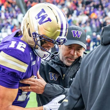Denzel Boston gets helped from the field in the fourth quarter against Illinois. 