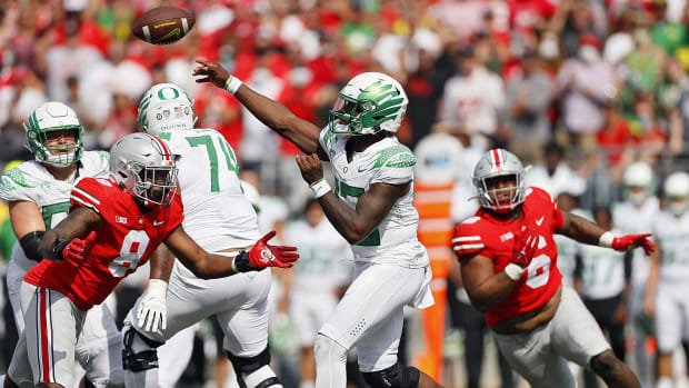 Oregon Ducks quarterback Anthony Brown (13) throws the ball against Ohio State Buckeyes defensive end Javontae Jean-Baptiste