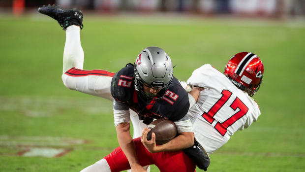 Thompson's Trakel Howard (12) is tackled by Central Phenix City's Daniel Cameron (17) as Central Phenix City faces Thompson