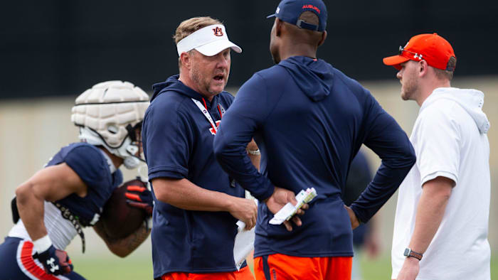 Auburn Tigers head coach Hugh Freeze talks with offensive coordinator Derrick Nix during practice at