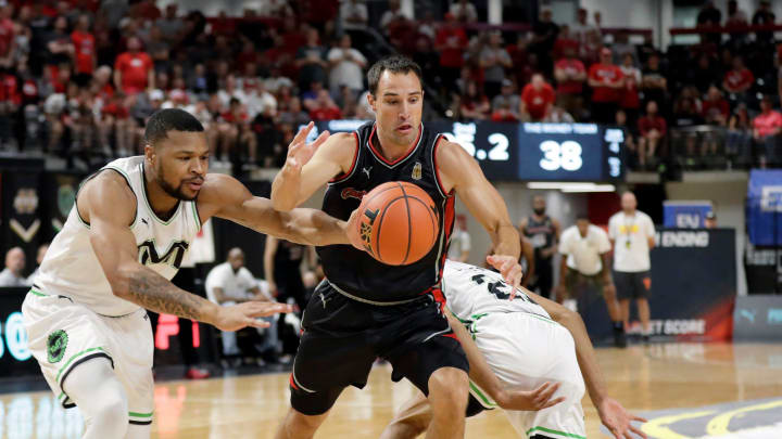 Carmen's Crew Aaron Craft (4) comes up with the ball against The Money Team Taylor Smith (9) in the second quarter of their game during the Columbus Regional of the 2021 The Basketball Tournament at Covelli Center in Columbus, Ohio on July 27, 2021.

Ceb Carmens Crew 0729 Kwr 16