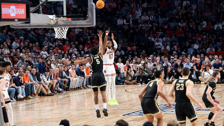 Auburn Tigers guard Miles Kelly (13) takes a jump shot as Auburn Tigers take on Purdue Boilermakers at Legacy Arena in Birmingham, Ala., on Saturday, Dec. 21, 2024. Auburn Tigers lead Purdue Boilermakers 41-26 at halftime.