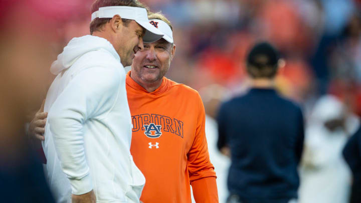 Mississippi Rebels head coach Lane Kiffin and Auburn Tigers head coach Hugh Freeze talk during warm ups before Auburn Tigers take on Mississippi Rebels at Jordan-Hare Stadium in Auburn, Ala., on Saturday, Oct. 21, 2023.