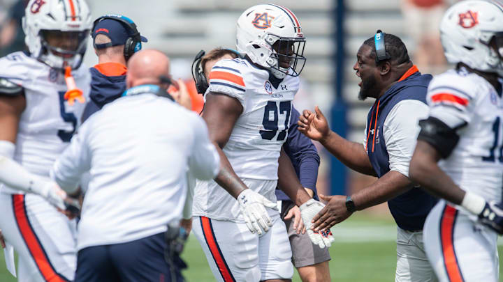 Auburn Tigers defensive tackles coach Vontrell King-Williams celebrates a stop with his team during the A-Day spring game at Jordan-Hare Stadium in Auburn, Ala., on Saturday, April 6, 2024.