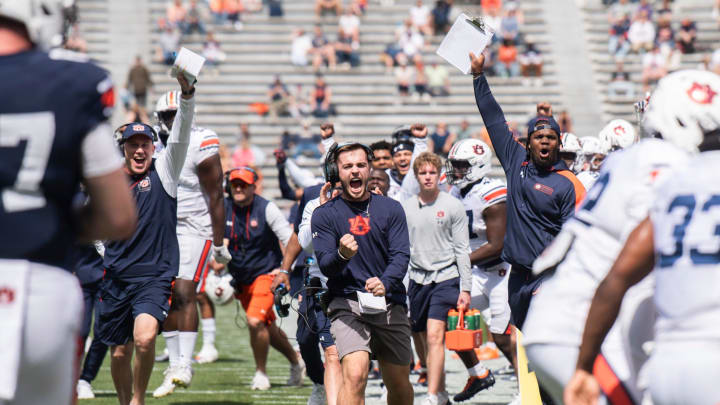 Auburn Tigers defensive coaches celebrate a stop during the A-Day spring game at Jordan-Hare Stadium in Auburn, Ala., on Saturday, April 6, 2024.