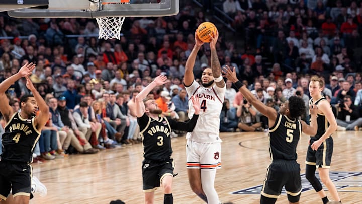Auburn Tigers forward Johni Broome (4) goes up for a layup on Purdue Boilermakers guard Braden Smith (3) as Auburn Tigers take on Purdue Boilermakers at Legacy Arena in Birmingham, Ala., on Saturday, Dec. 21, 2024. Auburn Tigers lead Purdue Boilermakers 41-26 at halftime.