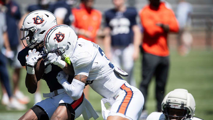 Auburn Tigers wide receiver Bryce Cain (6) is tackled by Auburn Tigers safety Jahquez Robinson (30) during Auburn Tigers A-Day football practice at Jordan-Hare Stadium in Auburn, Ala., on Saturday, April 12, 2025.