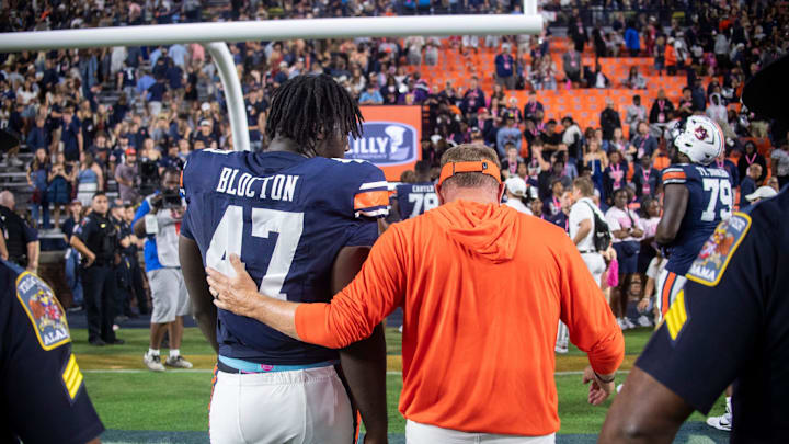 Auburn Tigers head coach Hugh Freeze walks off the field with Auburn Tigers defensive lineman Malik Blocton (47) as Auburn Tigers take on Missouri Tigers at Jordan-Hare Stadium in Auburn, Ala. on Saturday, Oct. 18, 2025. Missouri Tigers defeated the Auburn Tigers 23-17 in 2OT.
