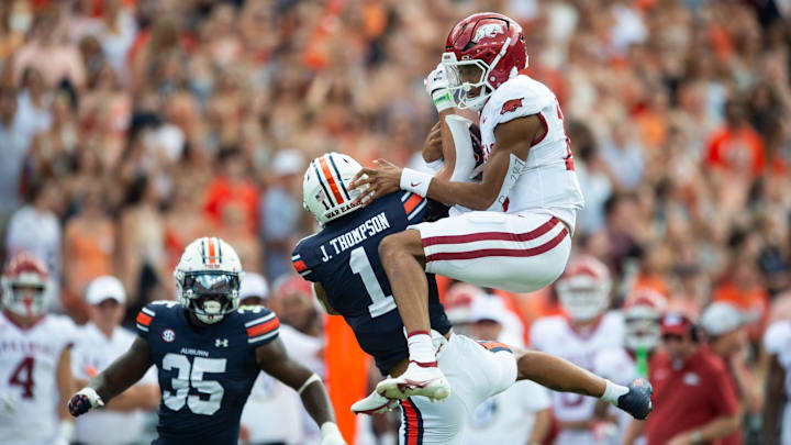 Arkansas Razorbacks quarterback Taylen Green (10) fails to hurdle over Auburn Tigers defensive back Jerrin Thompson (1) as Auburn Tigers take on Arkansas Razorbacks at Jordan-Hare Stadium in Auburn, Ala., on Saturday, Sept. 21, 2024. Arkansas Razorbacks lead Auburn Tigers 7-0 at halftime.