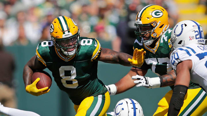 Green Bay Packers running back Josh Jacobs (8) runs for a first down against Indianapolis Colts safety Nick Cross (20) during their football game Sunday, September 15, 2024, at Lambeau Field in Green Bay, Wisconsin.