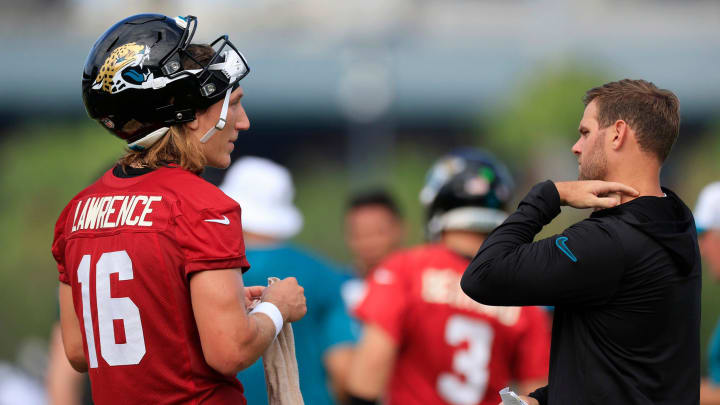 Jacksonville Jaguars quarterback Trevor Lawrence (16) and offensive coordinator Press Taylor talk during the third day of an NFL football training camp practice Friday, July 26, 2024 at EverBank Stadium’s Miller Electric Center in Jacksonville, Fla.