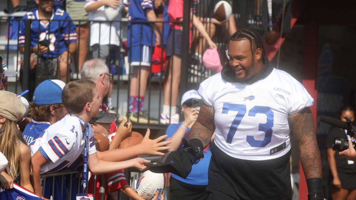 Bills Dion Dawkins high-fives fans as he heads towards the field.