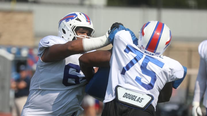 Bills O'Cyrus Torrence pushes at Richard Gouraige during practice at Bills training camp.