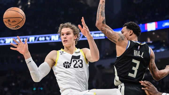 Dec 17, 2022; Milwaukee, Wisconsin, USA; Utah Jazz forward Lauri Markkanen (23) and Milwaukee Bucks guard George Hill (3) reach for a rebound in the second quarter at Fiserv Forum. Mandatory Credit: Benny Sieu-USA TODAY Sports