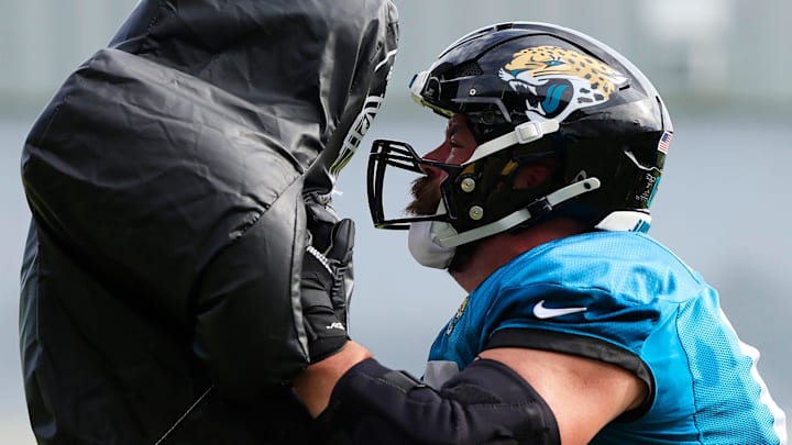 Jacksonville Jaguars center Mitch Morse (65) hits a sled during the third day of an NFL football training camp practice Friday, July 26, 2024 at EverBank Stadium’s Miller Electric Center in Jacksonville, Fla.