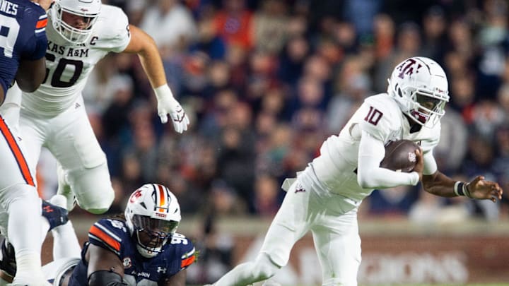 Auburn Tigers defensive lineman Philip Blidi (96) trips up Texas A&M Aggies quarterback Marcel Reed (10) as Auburn Tigers take on Texas A&M Aggies at Jordan-Hare Stadium in Auburn, Ala., on Saturday, Sept. 7, 2024. Auburn Tigers lead Texas A&M Aggies 21-7 at halftime.